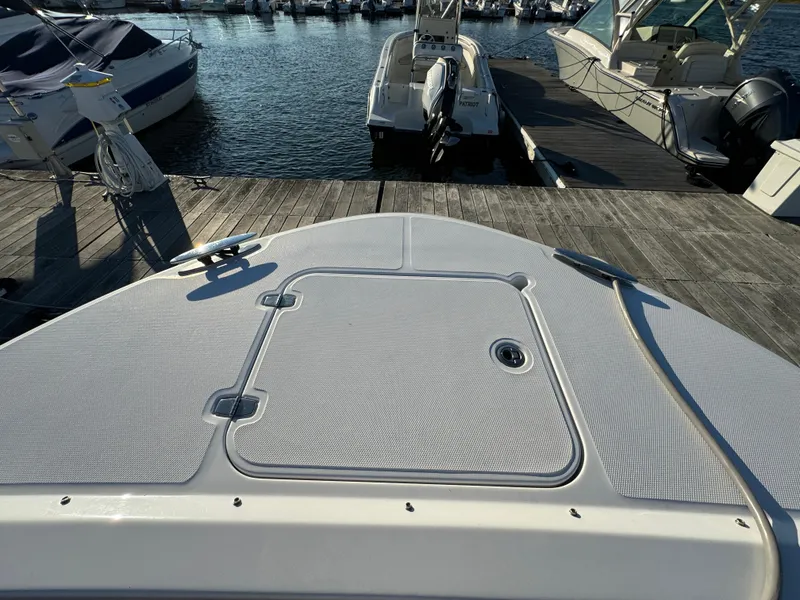 Slide: The Image of 2020 Southport 33 DC boat docked at marina, showcasing bow deck and hatch. - 34