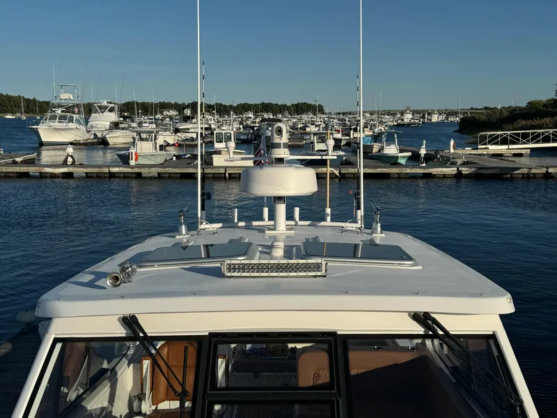 Slide: The Image of 2020 Southport 33 DC boat docked in a marina with other vessels. - 37