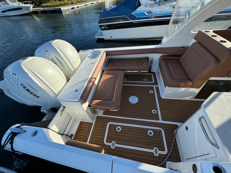 Slide: The Image of 2020 Southport 33 DC boat with Yamaha engines, featuring spacious seating and teak flooring. - 6