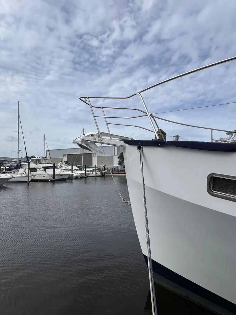 Slide: The Image of Kadey-Krogen 48 yacht docked at marina, 1996 model, under cloudy sky. - 12