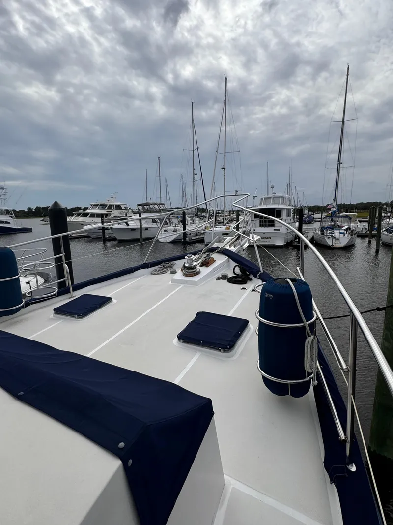 Slide: The Image of Kadey-Krogen 48 yacht deck, 1996 model, docked at marina under cloudy sky. - 18