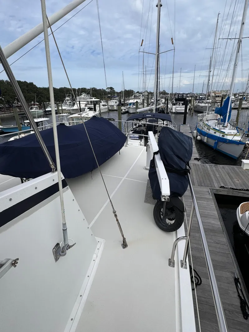 Slide: The Image of Kadey-Krogen 48 yacht docked at marina, 1996 model, with covered equipment on deck. - 21
