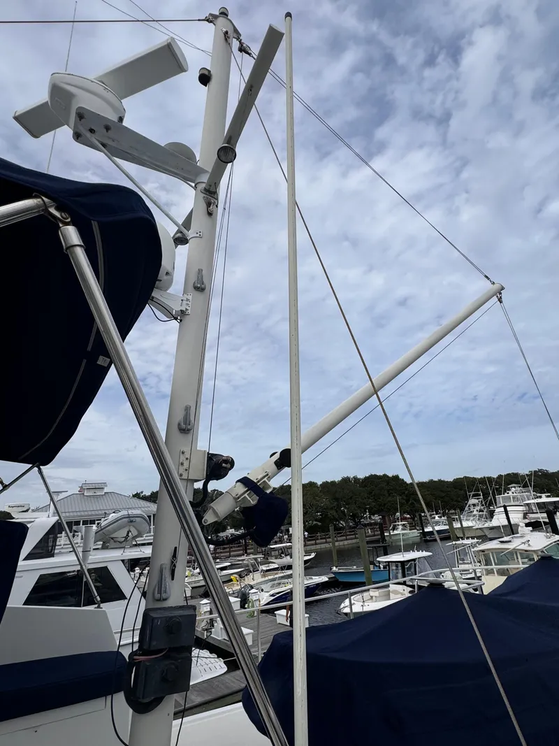 Slide: The Image of Kadey-Krogen 48 yacht mast and rigging, 1996 model, docked at marina under cloudy sky. - 22