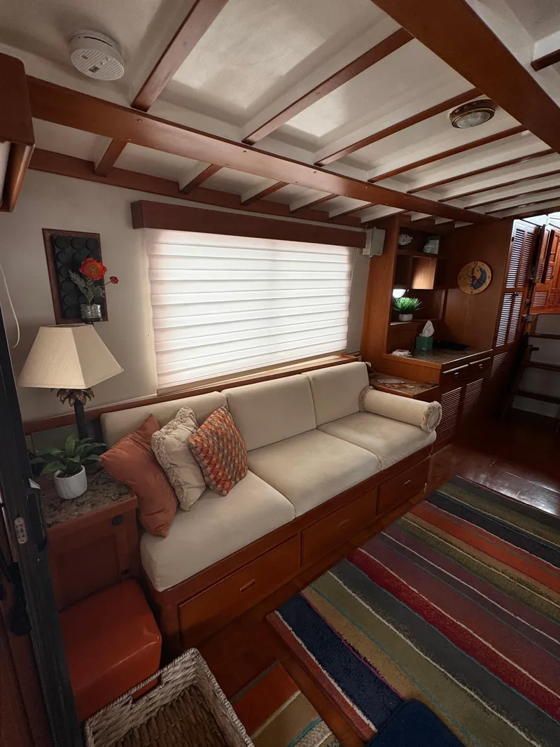 Slide: The Image of Cozy interior of 1996 Kadey-Krogen 48 yacht with sofa, colorful rug, and wooden accents. - 31