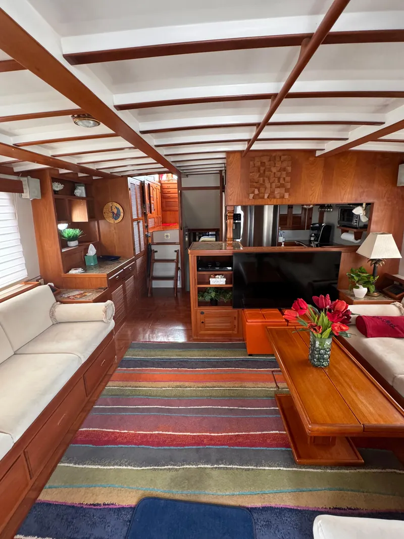 Slide: The Image of Luxurious 1996 Kadey-Krogen 48 yacht interior with cozy seating, vibrant rug, and elegant wood finishes. - 32