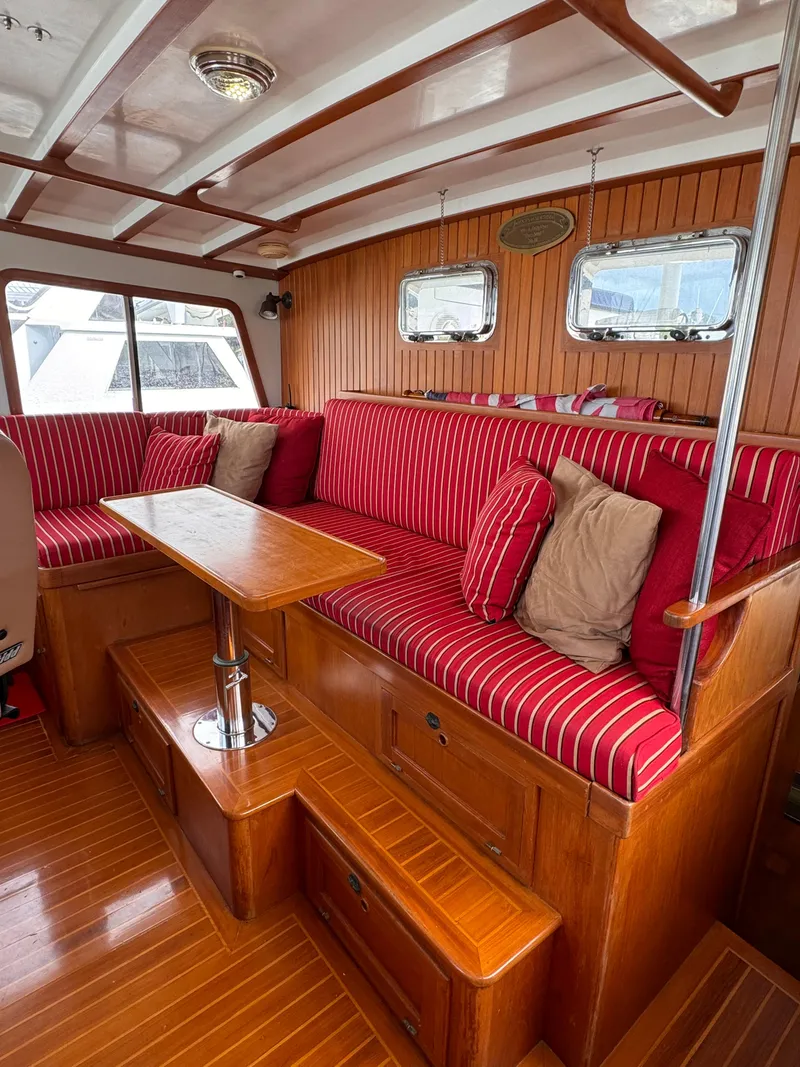 Slide: The Image of Interior of 1996 Kadey-Krogen 48 yacht with red-striped seating and wooden finishes. - 38