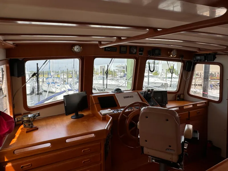Slide: The Image of Interior of 1996 Kadey-Krogen 48 boat with navigation equipment and marina view. - 39
