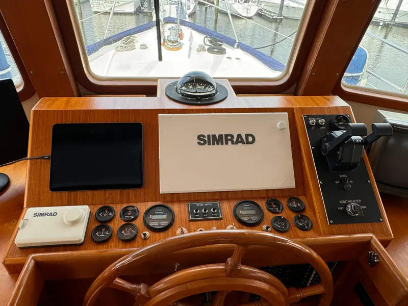 Slide: The Image of Helm of 1996 Kadey-Krogen 48 with Simrad navigation equipment and wooden steering wheel. - 40
