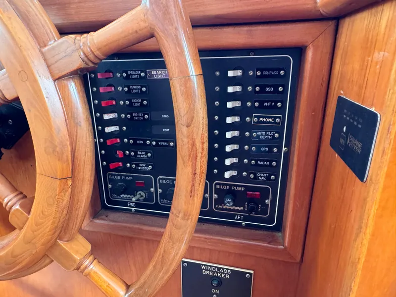 Slide: The Image of Control panel and wooden wheel of a 1996 Kadey-Krogen 48 boat. - 44