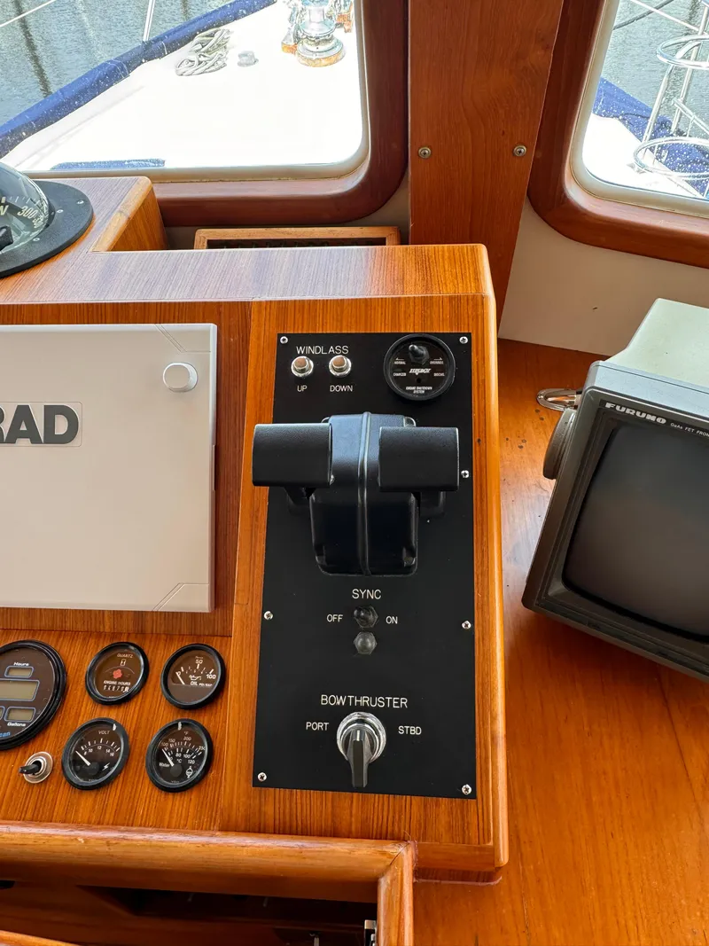 Slide: The Image of 1996 Kadey-Krogen 48 helm controls with gauges and navigation equipment. - 45