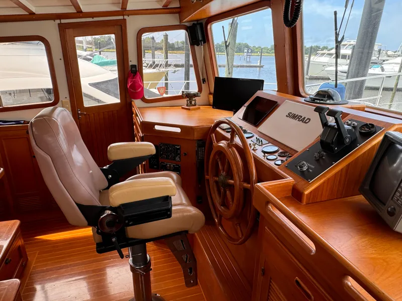 Slide: The Image of Interior of 1996 Kadey-Krogen 48 yacht with wooden helm and navigation equipment. - 46