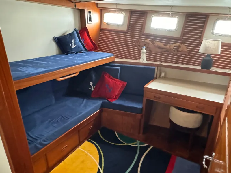 Slide: The Image of Cozy cabin interior of 1996 Kadey-Krogen 48 with bunk beds and nautical decor. - 48