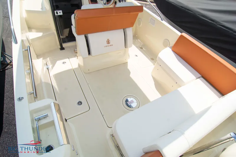 Slide: The Image of 2024 Capoforte CX270 boat interior with tan and white seating, spacious deck layout. - 11
