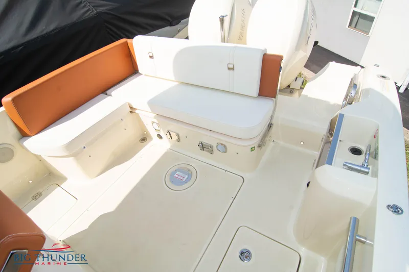 Slide: The Image of 2024 Capoforte CX270 boat interior with cushioned seating and storage compartments. - 12