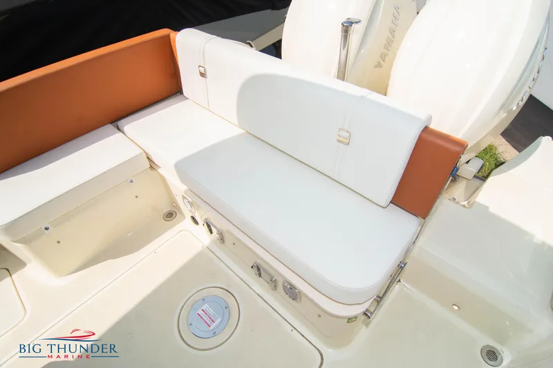 Slide: The Image of 2024 Capoforte CX270 boat seating area with white and orange cushions. - 14