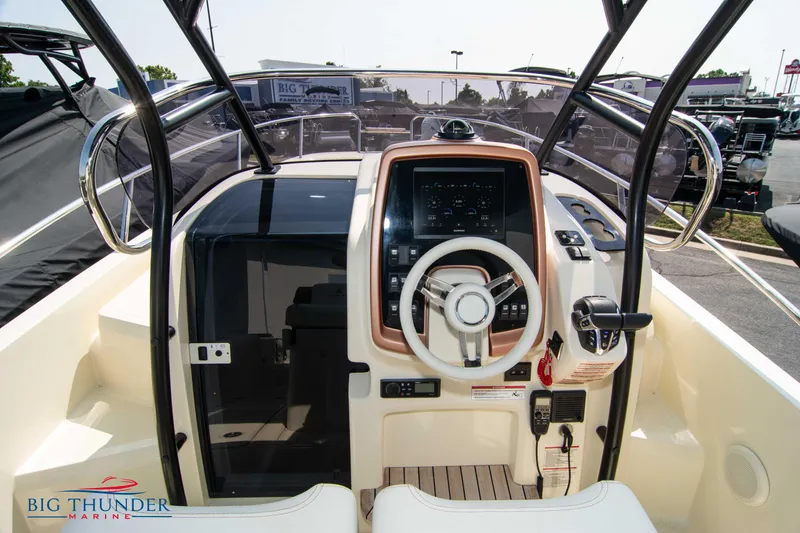 Slide: The Image of 2024 Capoforte CX270 boat cockpit with modern steering and control panel. - 18