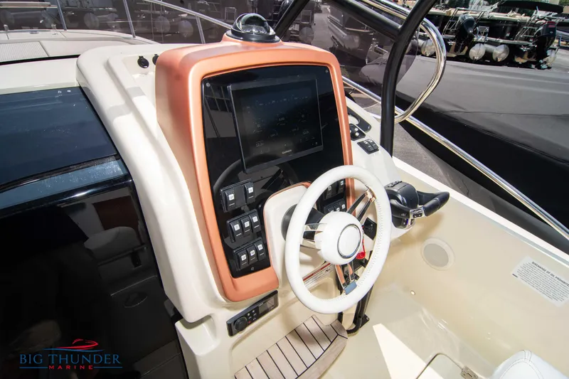 Slide: The Image of 2024 Capoforte CX270 boat helm with modern controls and steering wheel. - 21