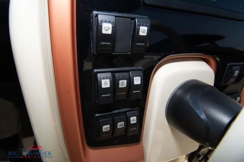 Slide: The Image of Control panel of 2024 Capoforte CX270 boat with various switches. - 23