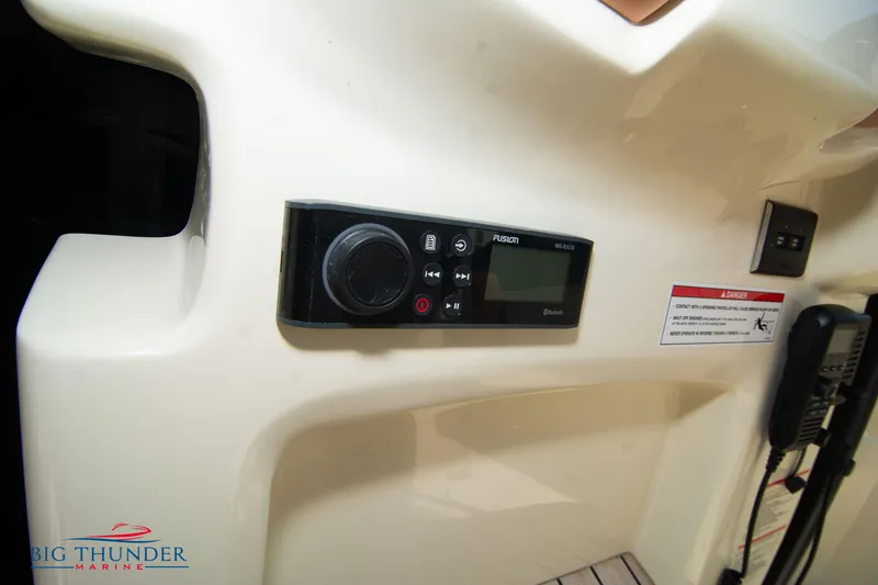 Slide: The Image of 2024 Capoforte CX270 boat dashboard with control panel and radio system. - 25