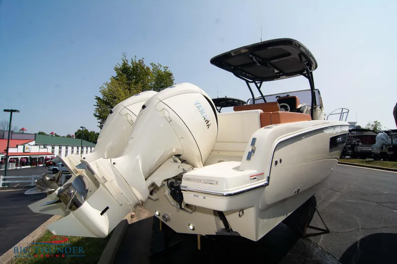 Slide: The Image of 2024 Capoforte CX270 boat with dual outboard engines, parked outdoors. - 3