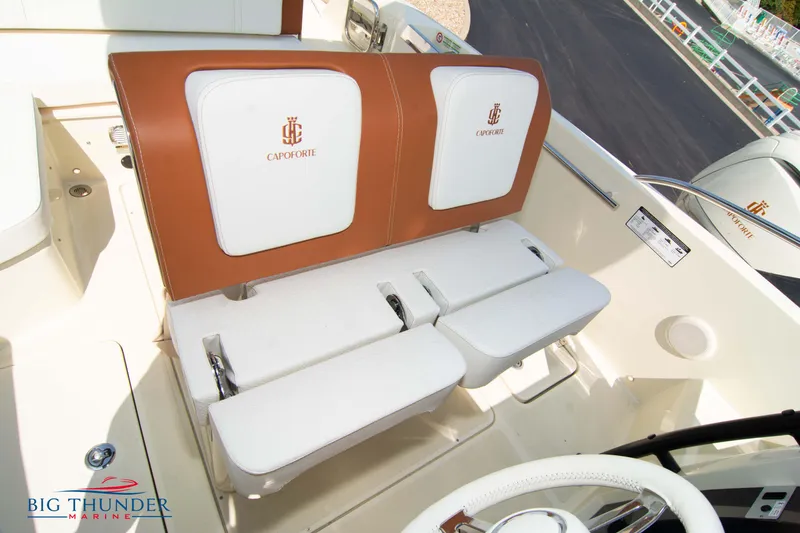 Slide: The Image of 2024 Capoforte CX270 boat interior with white and brown seating, featuring Big Thunder Marine logo. - 32