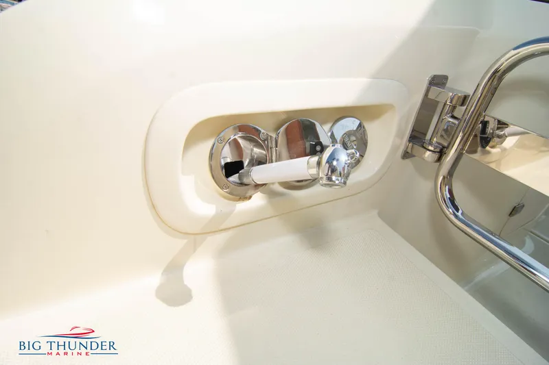 Slide: The Image of 2024 Capoforte CX270 boat interior detail with chrome fixtures and Big Thunder Marine logo. - 9