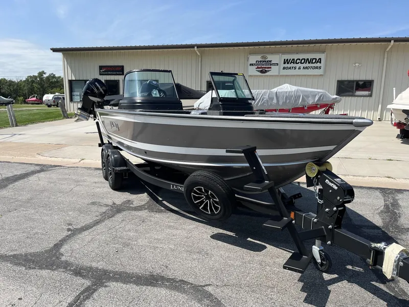 Slide: The Image of 2025 Lund 2075 Impact boat on trailer outside dealership. - 4