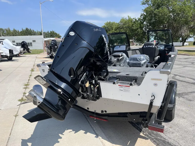 Slide: The Image of 2025 Lund 2075 Impact boat with powerful outboard motor on trailer. - 5