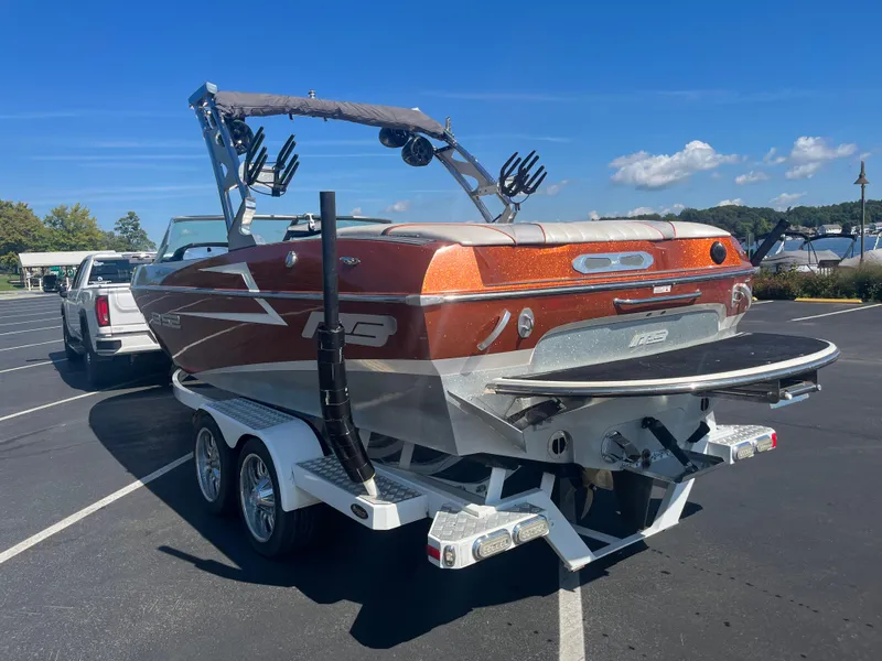 Slide: The Image of 2015 MB B52 23 boat on trailer in parking lot, sunny day. - 2