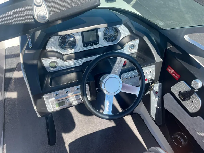 Slide: The Image of 2015 MB B52 23 boat dashboard with steering wheel and control panel. - 9