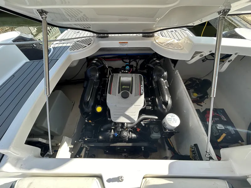 Slide: The Image of Engine compartment of a 2015 Monterey 244 FSX boat, showcasing the engine and interior layout. - 11