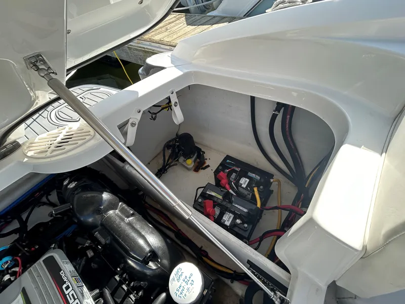 Slide: The Image of 2015 Monterey 244 FSX boat engine compartment with batteries and wiring. - 12