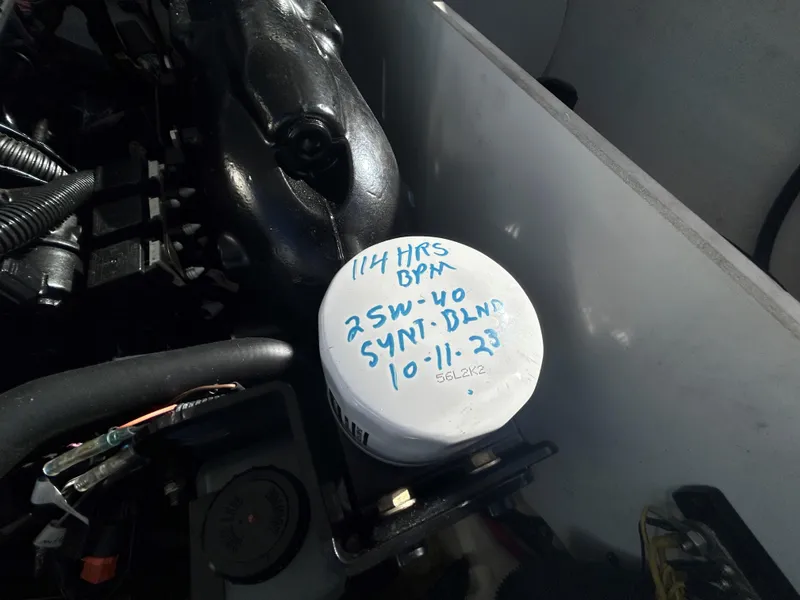 Slide: The Image of Engine compartment of 2015 Monterey 244 FSX with oil filter details handwritten. - 13