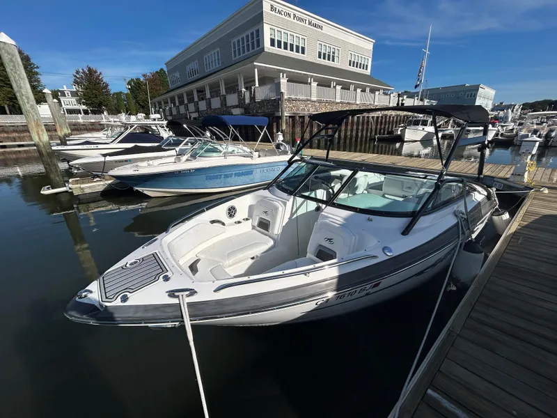 Slide: The Image of 2015 Monterey 244 FSX boat docked at marina with clear skies. - 7