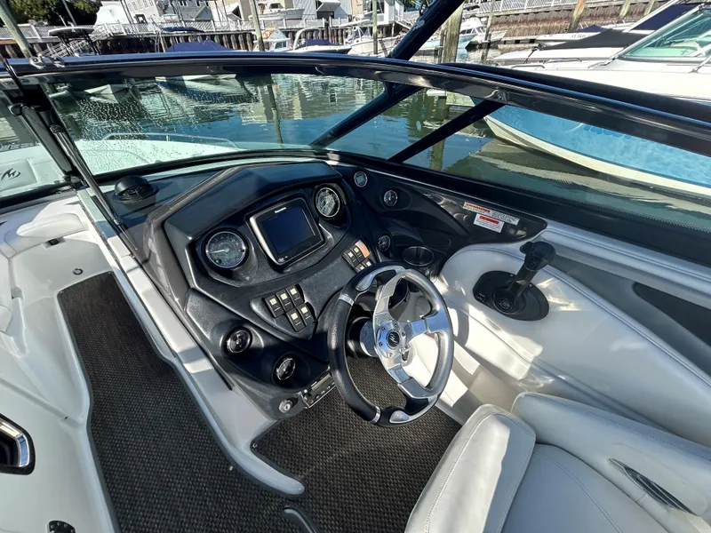 Slide: The Image of 2015 Monterey 244 FSX boat cockpit with steering wheel and control panel. - 9