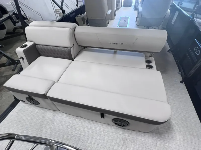 Slide: The Image of 2024 Harris Sunliner 230 boat interior with plush seating and modern design. - 10