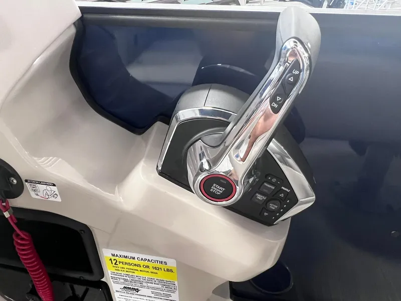 Slide: The Image of 2024 Harris Sunliner 230 boat throttle control with start/stop button and capacity label. - 15