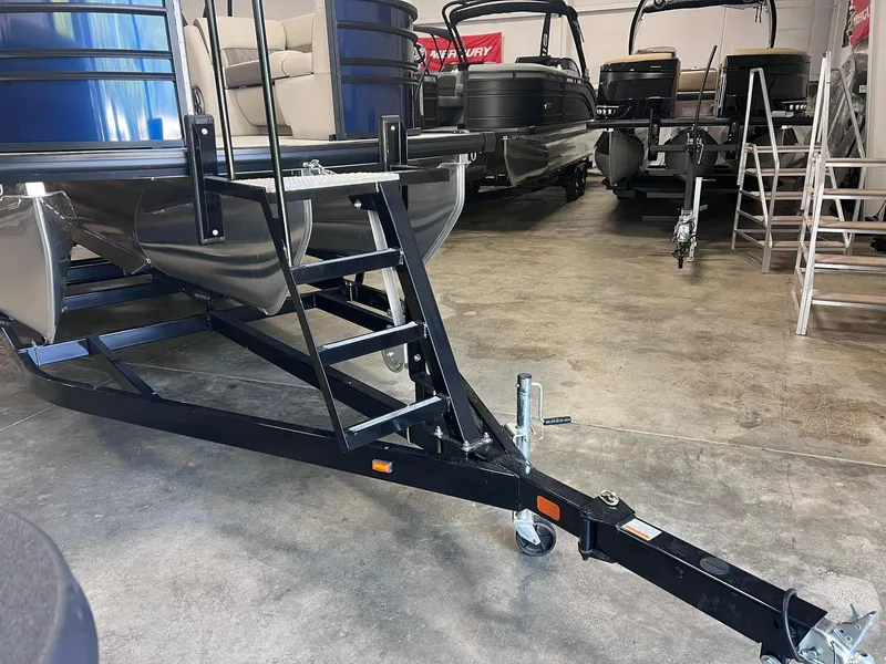 Slide: The Image of 2024 Harris Sunliner 230 pontoon boat on trailer in showroom. - 24