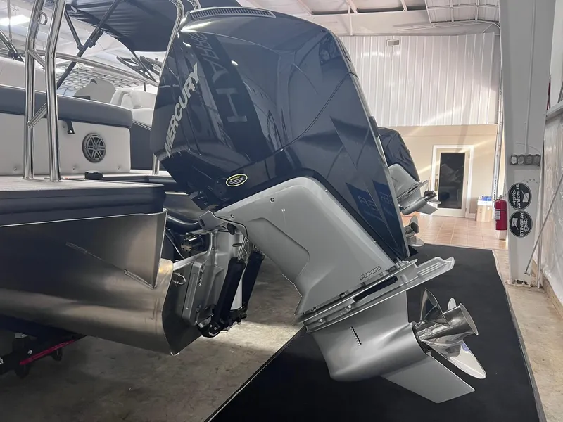 Slide: The Image of 2024 Harris Sunliner 230 with Mercury outboard motor in showroom. - 26
