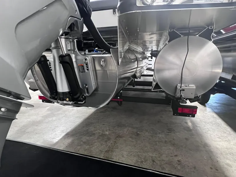 Slide: The Image of 2024 Harris Sunliner 230 pontoon boat underside view in a showroom. - 27