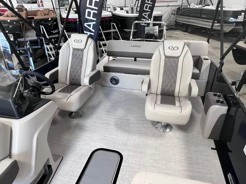Slide: The Image of 2024 Harris Sunliner 230 boat interior with plush seating and modern design. - 7