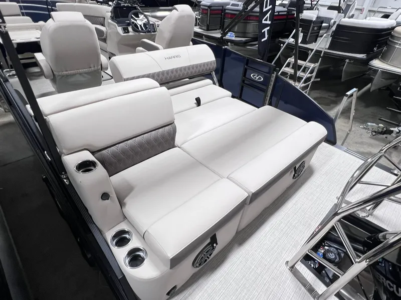 Slide: The Image of 2024 Harris Sunliner 230 boat interior with plush seating and cup holders. - 8