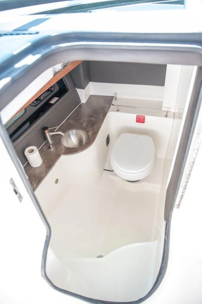 Slide: The Image of 2017 Sea Ray 350 SLX boat bathroom interior with sink and toilet. - 4