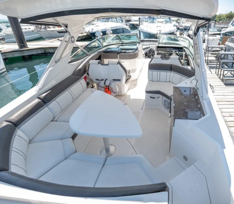 Slide: The Image of 2017 Sea Ray 350 SLX boat interior with seating and table at marina. - 5
