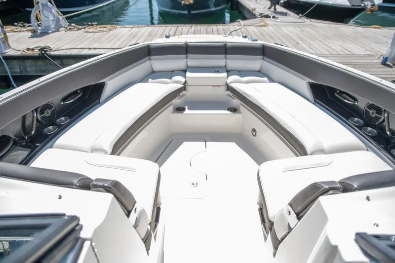 Slide: The Image of 2017 Sea Ray 350 SLX boat interior with white seating and dock view. - 9