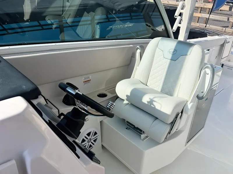 Slide: The Image of 2025 Sailfish 316 DC boat interior with luxurious captain's seat and steering wheel. - 10