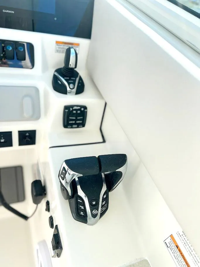 Slide: The Image of Control panel of 2025 Sailfish 316 DC boat with modern throttle and joystick. - 11