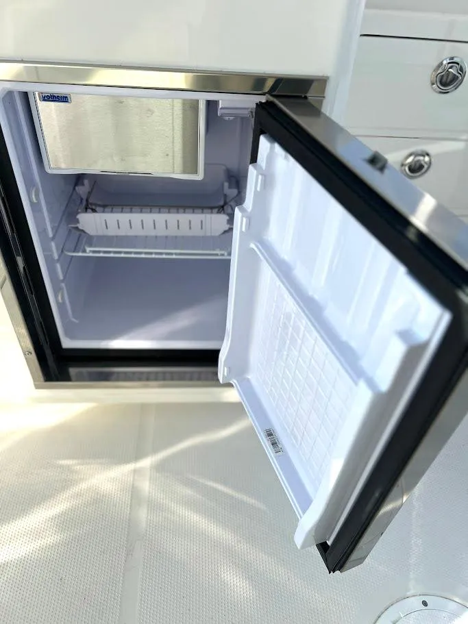 Slide: The Image of Open refrigerator on Sailfish 316 DC boat, 2025 model, with stainless steel finish. - 14