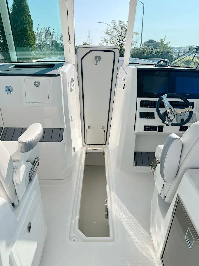 Slide: The Image of 2025 Sailfish 316 DC boat interior with modern helm and seating. - 15