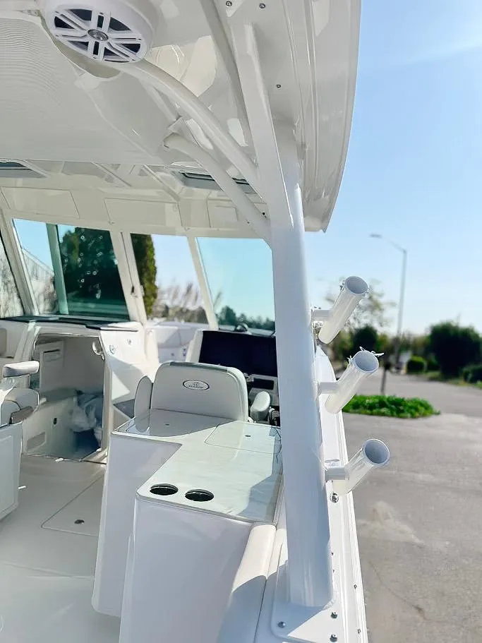 Slide: The Image of 2025 Sailfish 316 DC boat interior with rod holders and seating, showcasing modern design. - 17